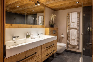 Master en suite bathroom with twin sinks and shower at Chalet Sirocco in Verbier