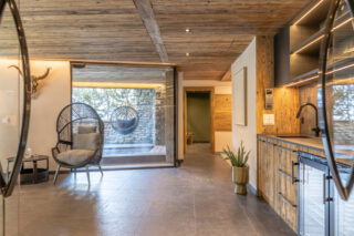Entrance to the spa area with kitchen at Chalet Sirocco in Verbier