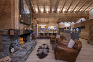 Armchairs in front of the open fire at Penthouse Trieze Etoiles in Verbier