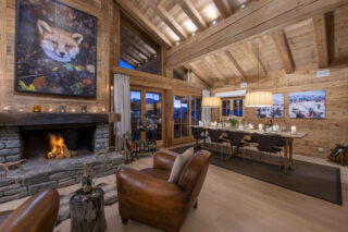 Open fireplace and dining area at Penthouse Treize Etoiles in Verbier