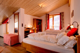 Double bedroom 4 configured with twin beds at Chalet Gemini in Zermatt