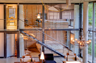 Ground and first floor bedrooms with glass walls seen from the living space at the Heinz Julen Loft in Zermatt