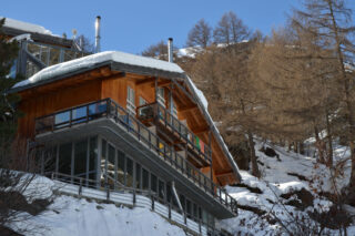 Exterior view from below in winter of the Heinz Julen Residence in Zermatt