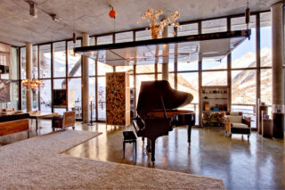 Grand piano in the living space at the Heinz Julen Loft in Zermatt