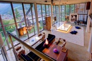 Living space with six metre high windows at the Heinz Julen Loft in Zermatt