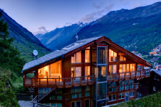 Rear exterior view of the Heinz Julen Penthouse in Zermatt at dusk