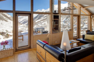 Custom build leather and wood sofas in the living space at the Heinz Julen Penthouse in Zermatt