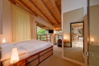 Main floor bedroom one at the Heinz Julen Penthouse in Zermatt
