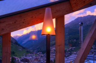 View from the window over the village at dusk at the Heinz Julen Penthouse in Zermatt