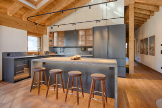 Open kitchen with Island and breakfast bar at Penthouse Weissmatten in Zermatt