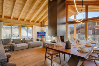 Dining area, fireplace and lounge at at Penthouse Weissmatten in Zermatt