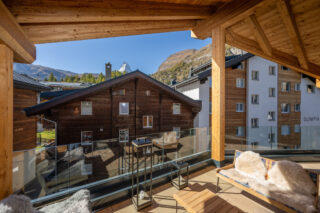 Main south-facing terrace with view of Zermatt skyline and the Matterhorn in the distance at at Penthouse Weissmatten in Zermatt