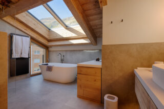 Master en suite bathroom with free-standing bath tub at Penthouse Weissmatten in Zermatt