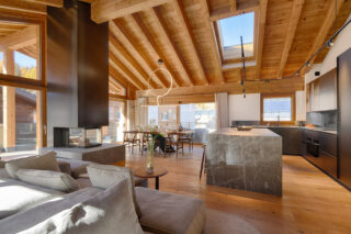Open plan living, dining and kitchen space at at Penthouse Weissmatten in Zermatt