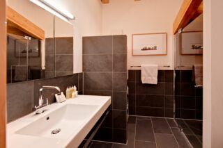 Bedroom one en suite shower room at Penthouse Zeus in Zermatt