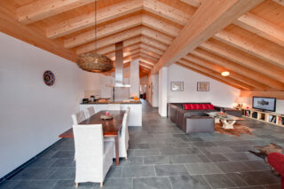 Open plan living, dining and kitchen area at Penthouse Zeus in Zermatt