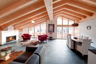 Open plan living and dining area at Penthouse Zeus in Zermatt