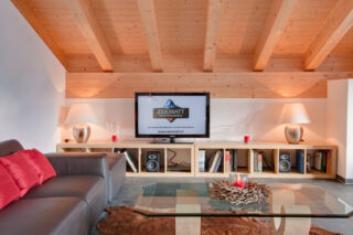 Media shelving with TV and speakers at Penthouse Zeus in Zermatt