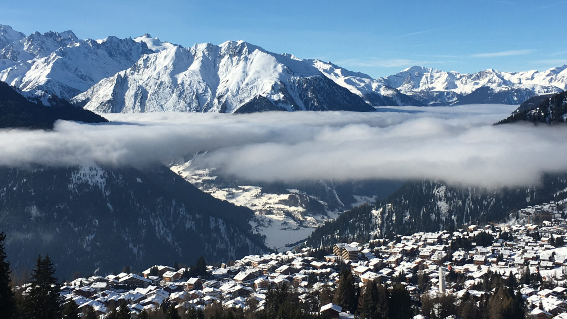 View over Verbier and the Val de Bagnes toward Catogne with a temperature inversion cloud layer